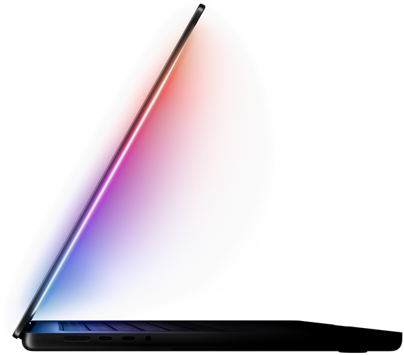 A slightly open MacBook Pro casts a multicolored glow from the screen onto the keyboard